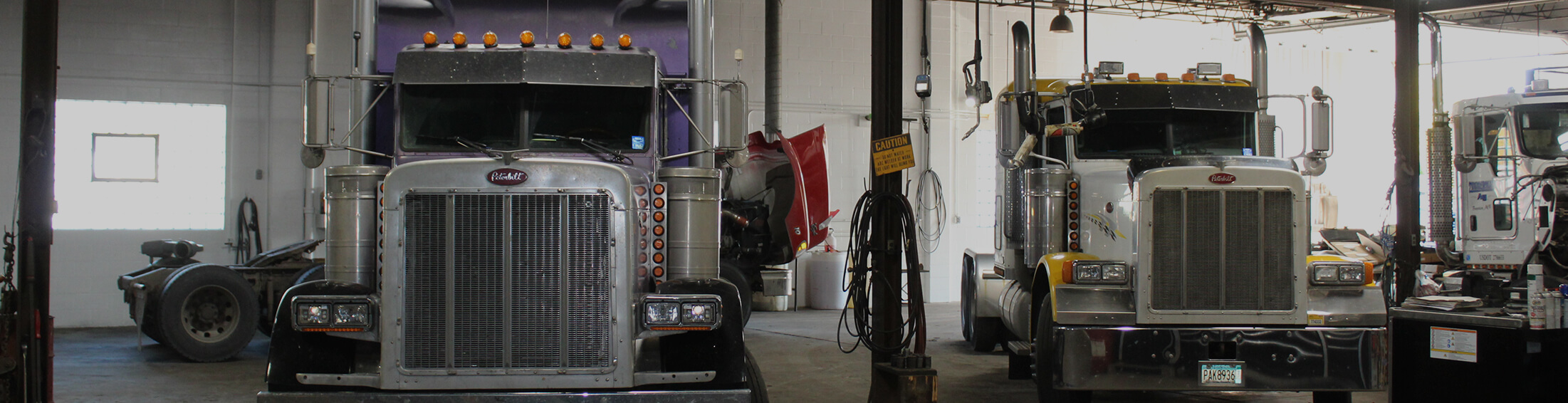 Semi tractors parked in the service bays at Melrose Truck Repair in Melrose, MN